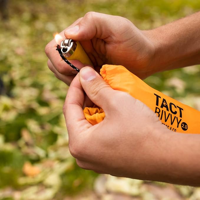 Survival Frog Tact Bivvy 2.0 Emergency Sleeping Bag w/Stuff Sack, Carabiner, Survival Whistle, ParaTinder - Compact, Lightweight, Waterproof, Reusable, Thermal Bivy Sack Cover, Shelter Kit